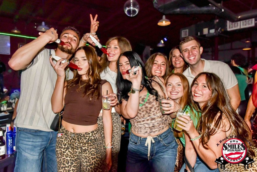 Friends celebrating in front of the stage