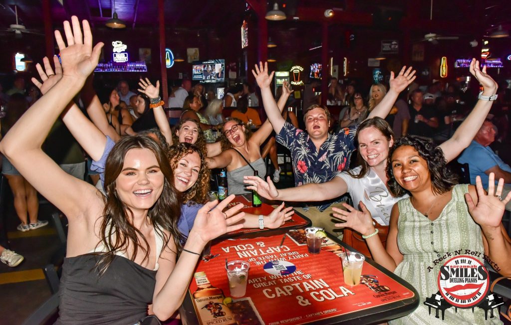Friends cheering at a front table