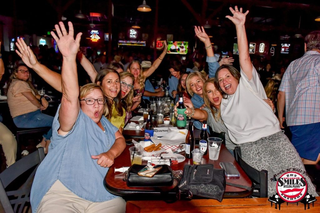 Friends cheering at a long table