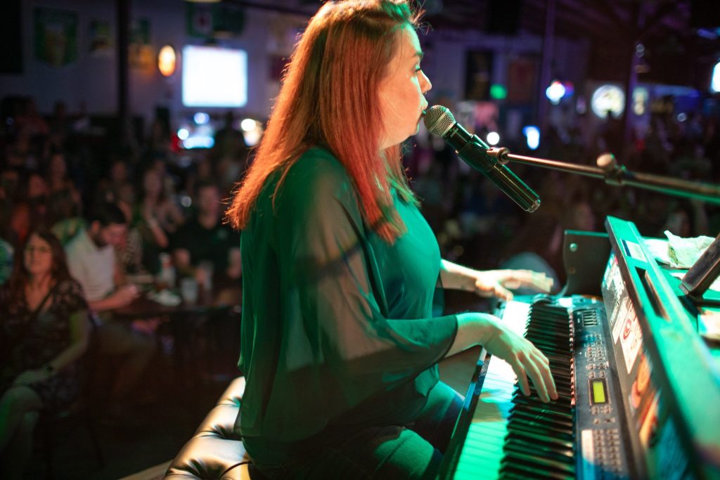 Entertainer singing at the keys during a Savannah Smiles show
